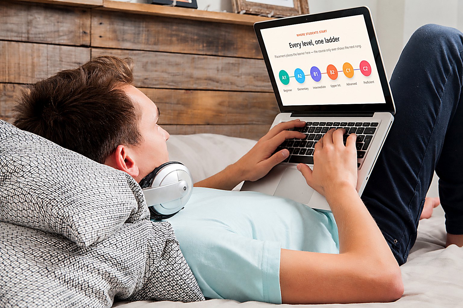 Student studying IELPS on a laptop while relaxing at home