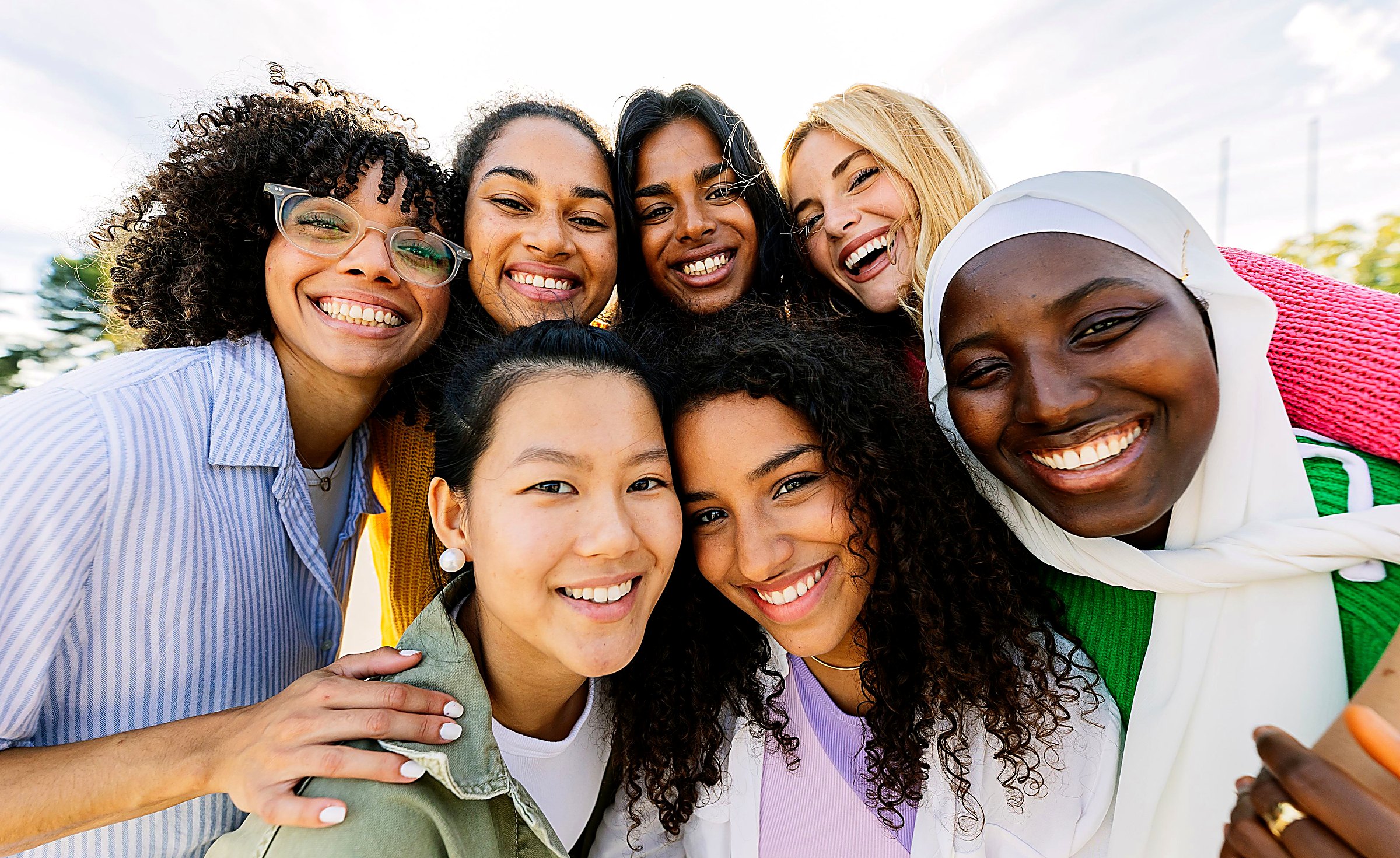 A diverse group of international IELPS learners smiling together